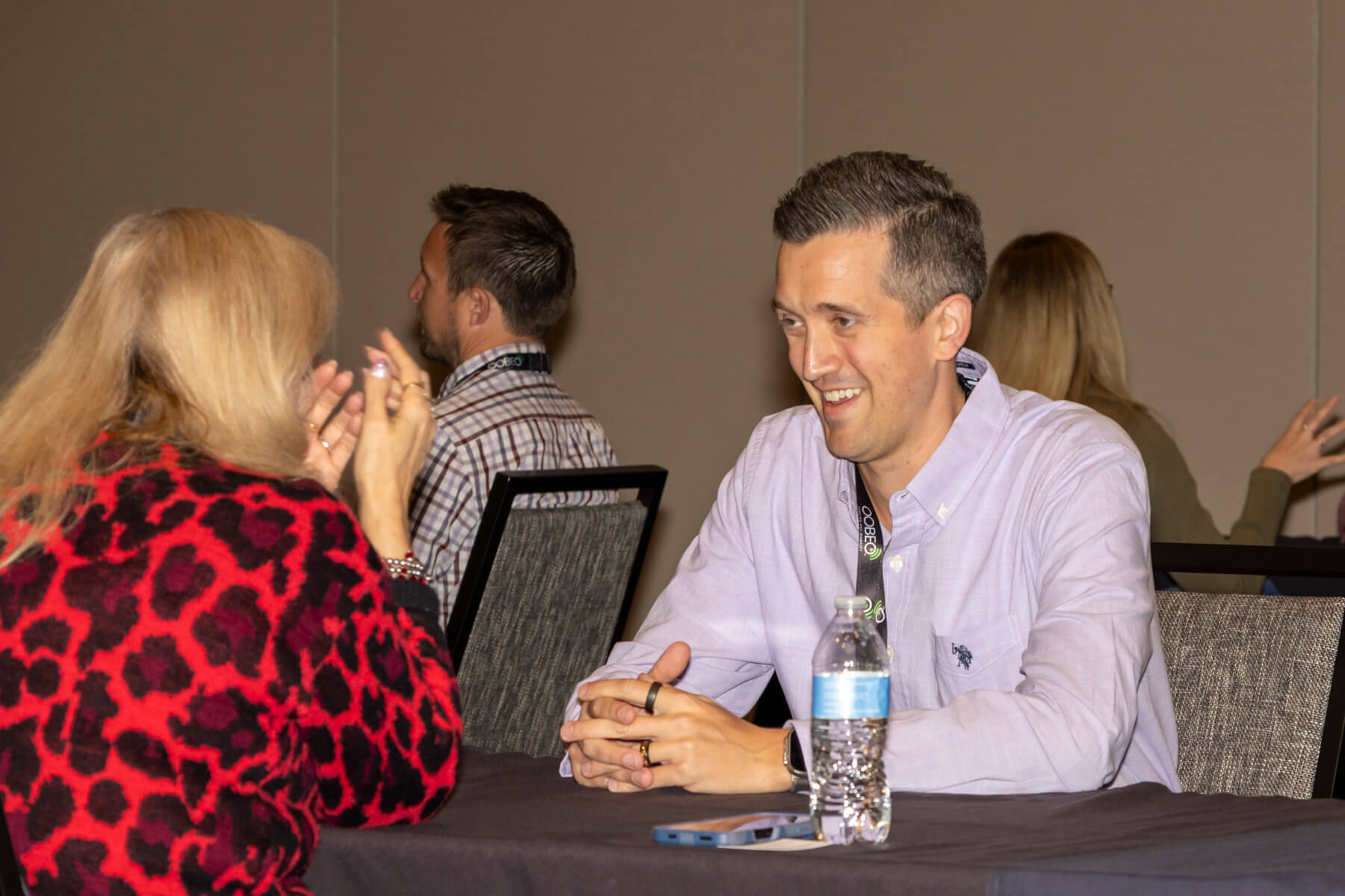 Two professionals in conversation during a networking session at the Parking Industry Expo.